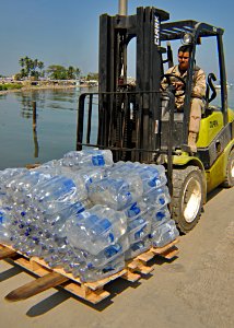 US Navy 100205-N-9643W-328 A Sailor moves bottles of water to be distributed in Killick, Haiti photo