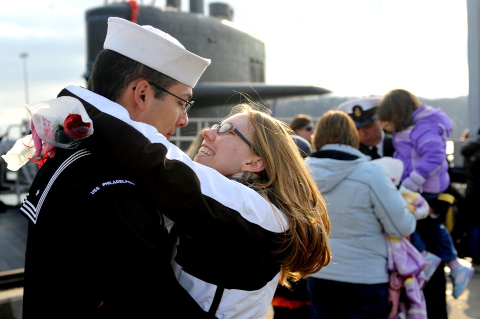 US Navy 100203-N-8467N-011 Machinist's Mate 2nd Class Trevor Fredrick hugs his girlfriend moments after the Los Angeles-class attack submarine USS Philadelphia (SSN 690) pulls into Submarine Base New London
