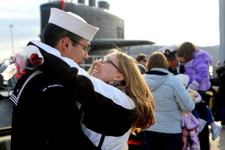 US Navy 100203-N-8467N-011 Machinist's Mate 2nd Class Trevor Fredrick hugs his girlfriend moments after the Los Angeles-class attack submarine USS Philadelphia (SSN 690) pulls into Submarine Base New London