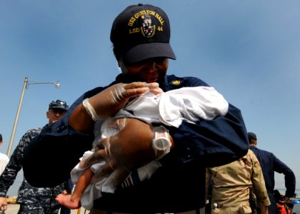 US Navy 100205-N-6676S-005 Chief Quartermaster Deenicia Canty holds a newborn baby at the Killick Haitian Coast Guard Base