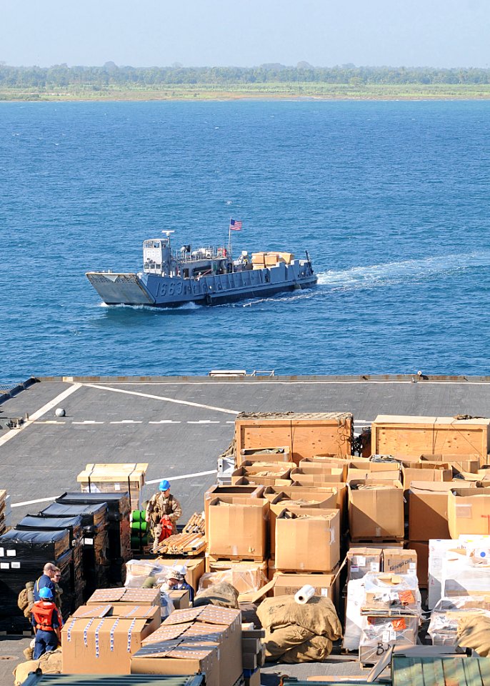 US Navy 100204-N-1082Z-031 Landing Craft Unit 1663 comes along side the amphibious dock landing ship USS Ashland (LSD 48) to receive supplies to assist with humanitarian and disaster relief operations