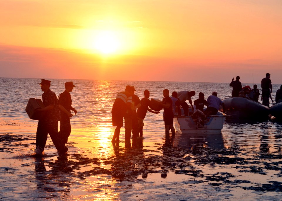US Navy 100204-N-4124C-004 Sailors assigned to the guided-missile cruiser USS Normandy (CG 60), unload humanitarian relief supplies to a village on the island of La Gonave, Haiti