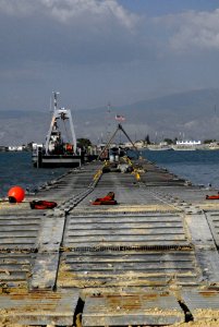 US Navy 100204-N-5787K-003 A temporary pier erected by Naval Beach Group (NGB) 2 is a mooring point for utility boats at the port in Port-au-Prince, Haiti