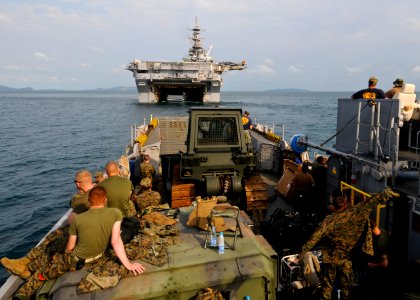 US Navy 100204-N-9950J-365 Marines assigned to the 31st Marine Expeditionary Unit return to the forward-deployed amphibious assault ship USS Essex (LHD 2) on a landing craft utility vehicle photo