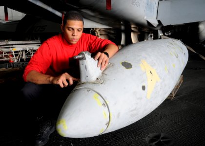 US Navy 100206-N-4236E-112 Aviation Ordnanceman Airman Apprentice Madison Hendrick performs corrosion repair on a drop tank aboard the Nimitz-class aircraft carrier USS Dwight D. Eisenhower (CVN 69)