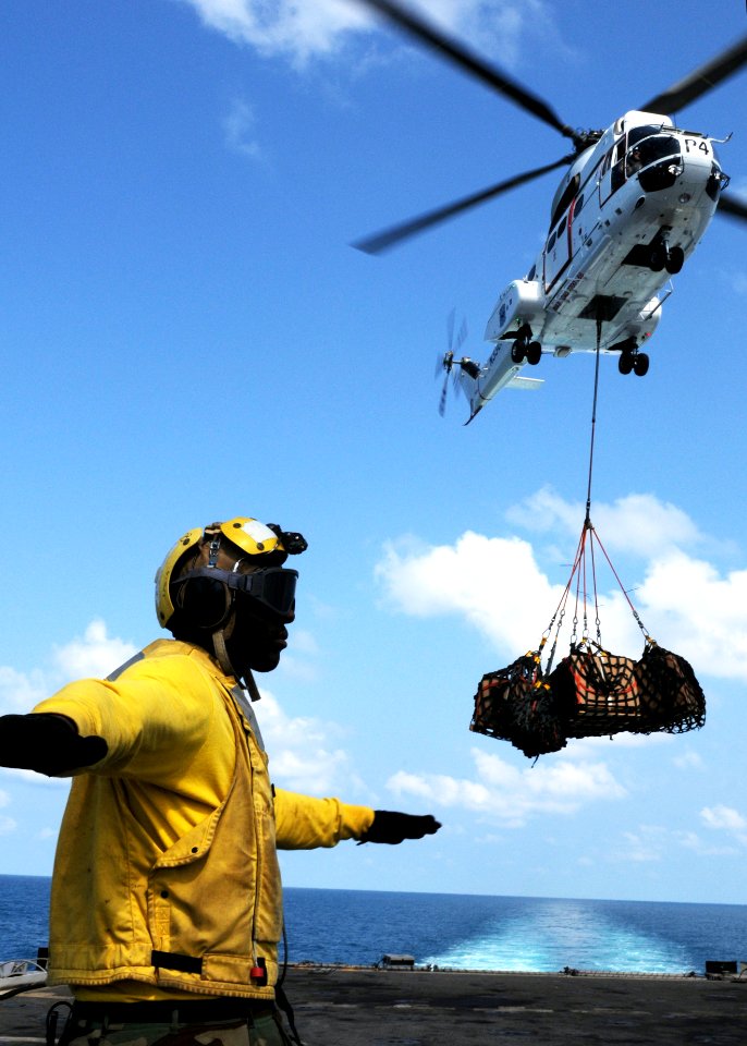 US Navy 100207-N-5538K-251 Aviation Boatswain's Mate Airman Tione M. Williams directs an SA-330J Puma helicopter