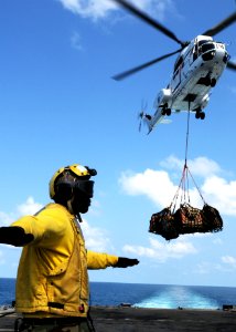 US Navy 100207-N-5538K-251 Aviation Boatswain's Mate Airman Tione M. Williams directs an SA-330J Puma helicopter