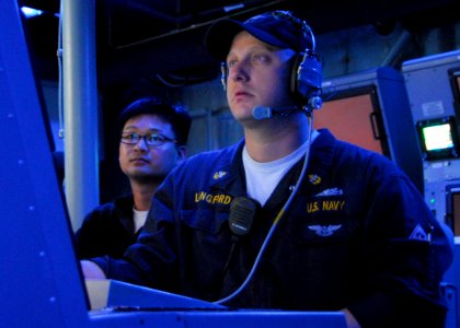 US Navy 100205-N-7058E-015 Chief Fire Controlman Donald Langford tracks a target for the MK-110 57mm gun aboard the littoral combat ship USS Freedom (LCS 1) during a combat systems exercise
