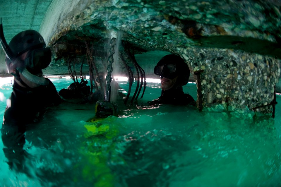 US Navy 100206-N-1134L-042 Divers drill guide holes into a damaged section of a pier at the port in Port-au-Prince, Haiti