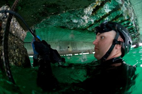 US Navy 100208-N-1134L-005 Staff Sgt. Micah Sherrod, an Army diver assigned to the 544th Engineer Dive Team, wraps wire around adjoining pieces of re-enforcement bar used to strengthen sections of pier in Port-au-Prince, Haiti