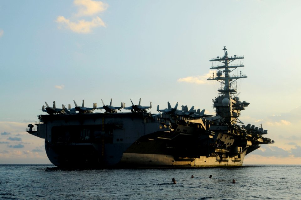 US Navy 100205-N-3038W-072 Rescue swimmers test the currents before an early morning swim call for Sailors aboard the aircraft carrier USS Nimitz (CVN 68)