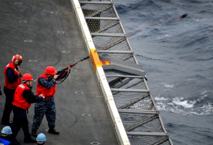 US Navy 100209-N-4774B-173 Sailors from the weapons department aboard the Nimitz-class aircraft carrier USS Carl Vinson (CVN 70) fire a shot line to the Military Sealift Command fleet replenishment oiler USNS Leroy Grumman (T-A