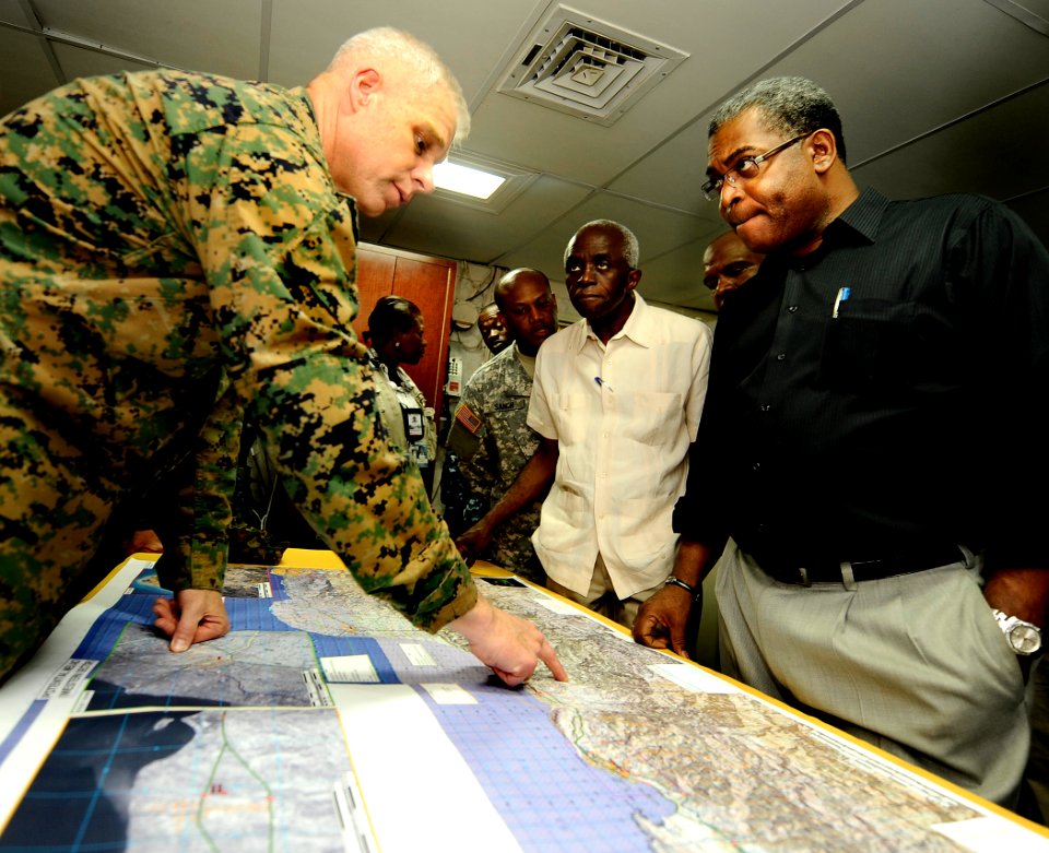 US Navy 100206-N-5345W-151 Haitian Prime Minister Jean-Max Bellerive listens as Col. Gareth Brandl explains relief operations