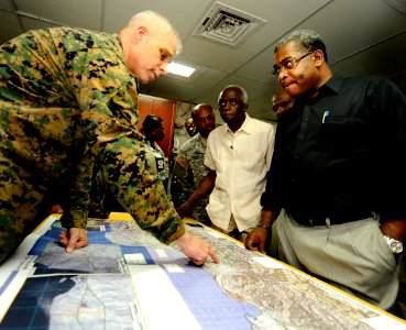 US Navy 100206-N-5345W-151 Haitian Prime Minister Jean-Max Bellerive listens as Col. Gareth Brandl explains relief operations