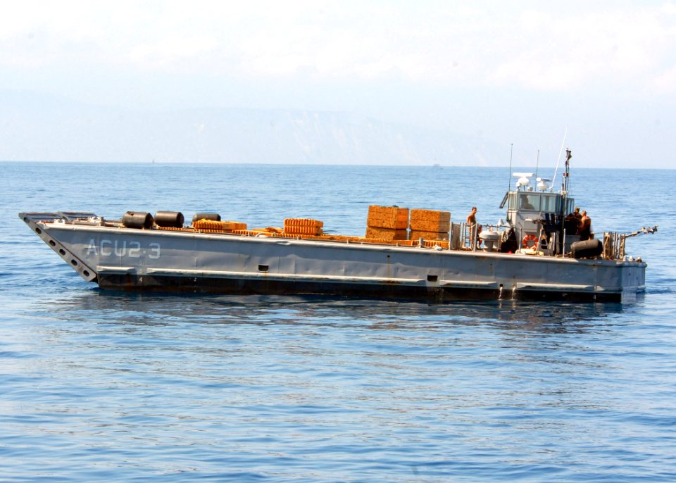 US Navy 100209-N-4971L-077 Landing craft mechanized boats from Assault Craft Unit (ACU) 2, depart the amphibious dock landing ship USS Fort McHenry (LSD 43) with relief supplies