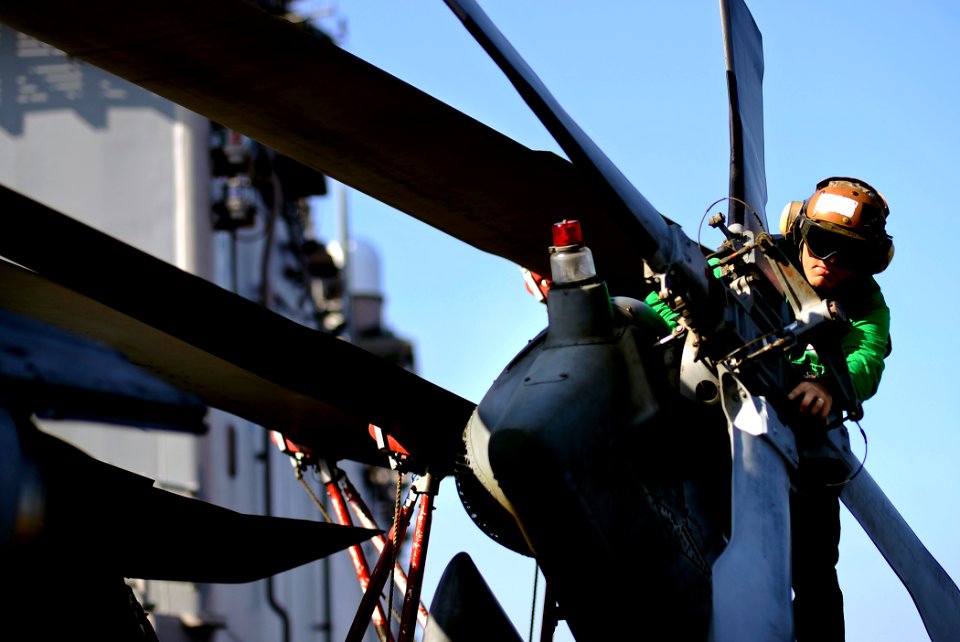 US Navy 100206-N-5345W-009 A Sailor assigned to the Sea Knights of Helicopter Sea Combat Squadron (HSC) 22 inspects the tail rotor of an MH-60S Sea Hawk helicopter prior to flight operations aboard the amphibious assault ship