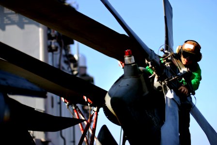 US Navy 100206-N-5345W-009 A Sailor assigned to the Sea Knights of Helicopter Sea Combat Squadron (HSC) 22 inspects the tail rotor of an MH-60S Sea Hawk helicopter prior to flight operations aboard the amphibious assault ship photo