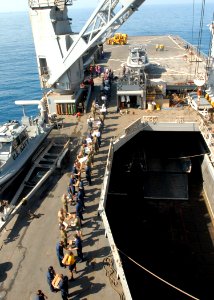 US Navy 100206-N-4971L-056 Sailors and Marines onload stores and relief supplies aboard the amphibious dock landing ship USS Fort McHenry (LSD 43)