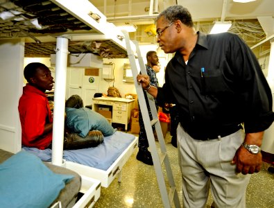 US Navy 100206-N-5345W-133 Haitian Prime Minister Jean-Max Bellerive visits with Haitian patients and their families in the medical ward of the amphibious assault ship USS Bataan (LHD 5)