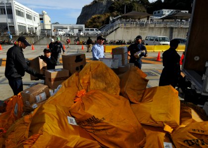 US Navy 100209-N-6233H-009 Sailors assigned to the Nimitz-class aircraft carrier USS George Washington (CVN 73) unload mail on the pier for delivery to the ship
