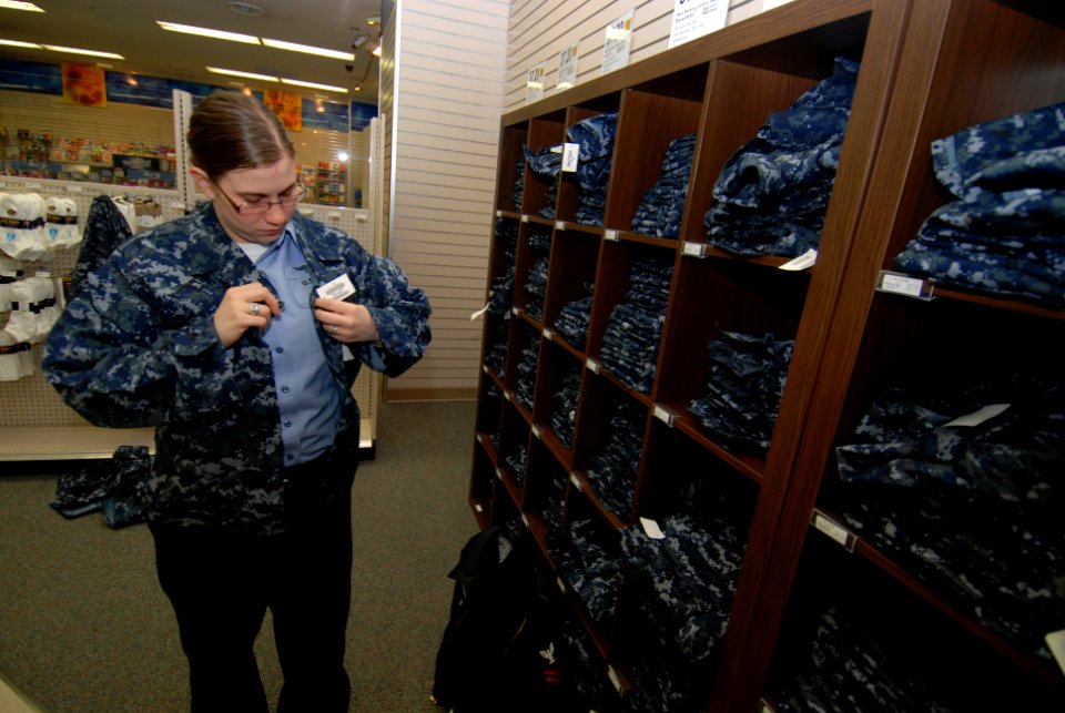 US Navy 100210-N-3283P-010 Aviation Ordnanceman 2nd Class Shaila Chaney, assigned to the aircraft carrier USS George Washington (CVN 73), tries on the Navy Working Uniform