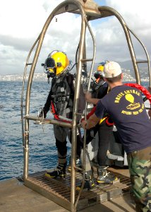 US Navy 100209-N-8288P-160 Navy Diver 2nd Class Todd Walsh and Navy Diver 2nd Class Matthew Trautman prepare to dive into the Mediterranean Sea