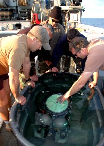 US Navy 100206-N-8288P-078 Sailors assigned to Mobile Diving and Salvage Unit (MDSU) 2) and Explosive Ordnance Disposal Mobile Unit (EODMU) 8 submerge a MK-16 Mod 1 underwater breathing apparatus to check for leaks photo