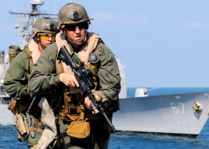 US Navy 100210-N-5538K-055 Staff Sgt. Chad Charlton, a member of the 31st Marine Expeditionary Unit (31st MEU) visit, board, search and seizure team leads team members to the bridge of the forward-deployed amphibious transport
