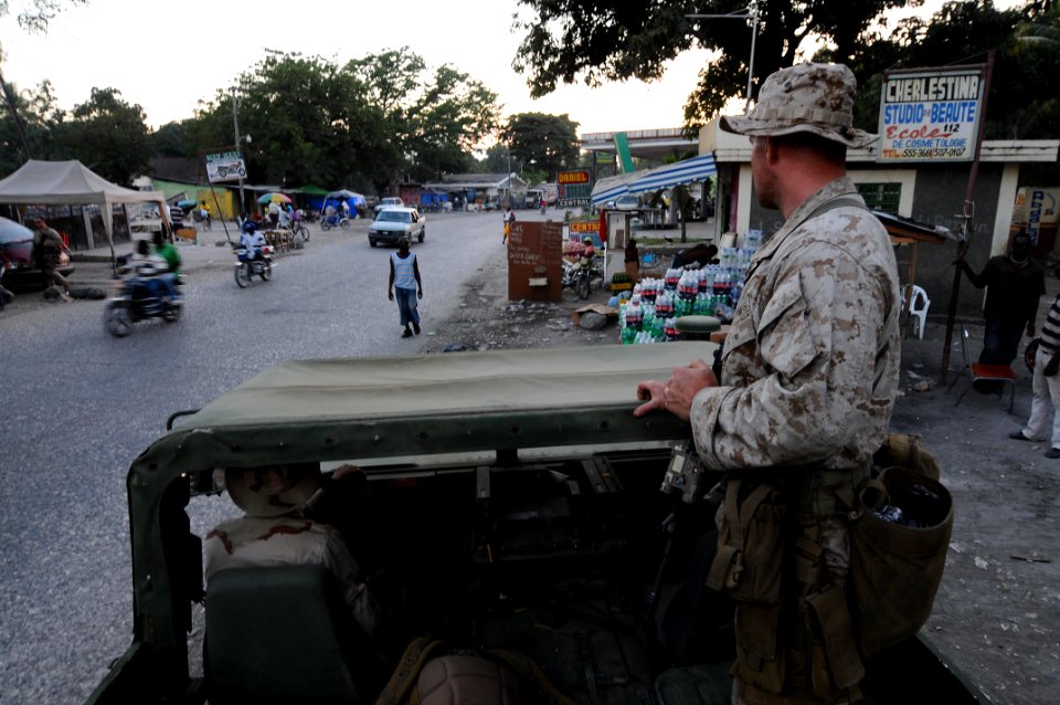 US Navy 100207-N-2735T-055 Sgt. Tom Maloney from the 24th Marine Expeditionary Unit (24th MEU) looks out at a crowded street during a reconnaissance patrol