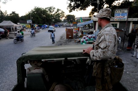 US Navy 100207-N-2735T-055 Sgt. Tom Maloney from the 24th Marine Expeditionary Unit (24th MEU) looks out at a crowded street during a reconnaissance patrol