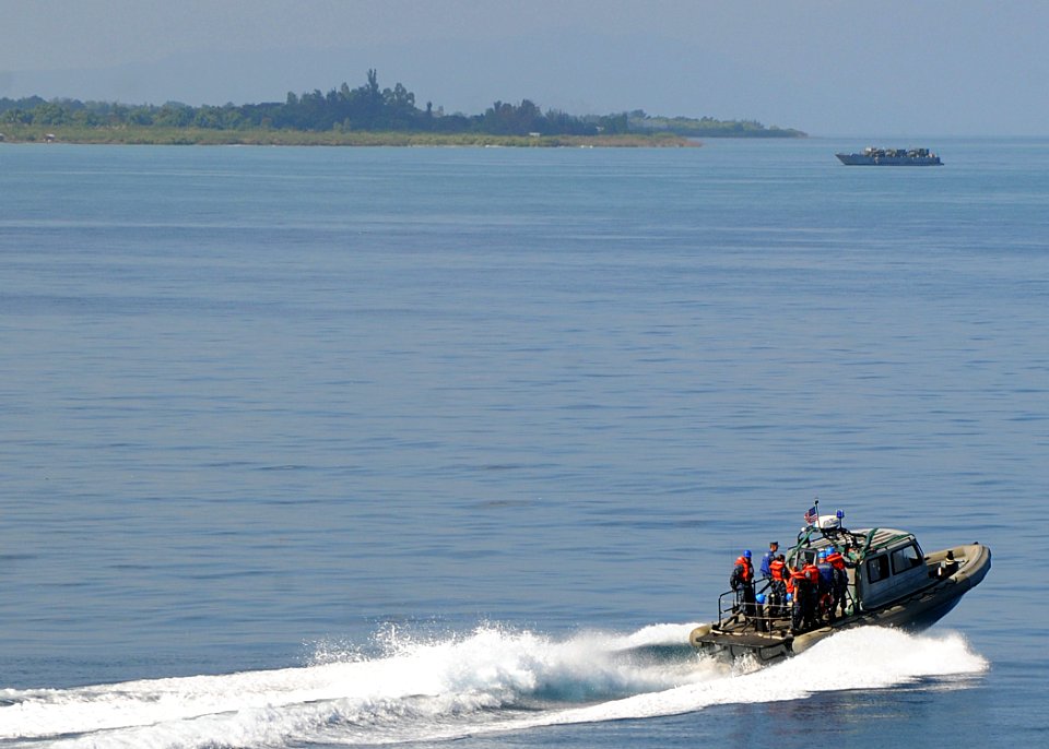 US Navy 100208-N-1082Z-062 A rigid hull inflatable boat from the amphibious dock landing ship USS Ashland (LSD 48), carries sailors to the multi-purpose amphibious assault ship USS Nassau (LHA 4) near the Haitian coast