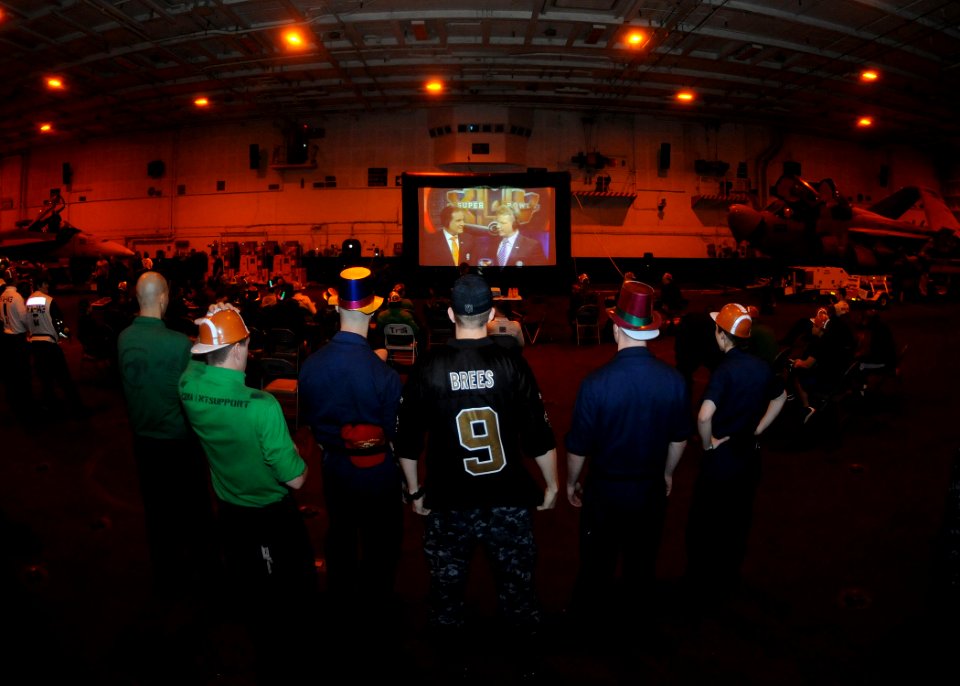 US Navy 100208-N-4236E-029 Sailors wait for Super Bowl XLIV to begin during an early-morning Super Bowl party in the hanger bay of the Nimitz-class aircraft carrier USS Dwight D. Eisenhower (CVN 69)
