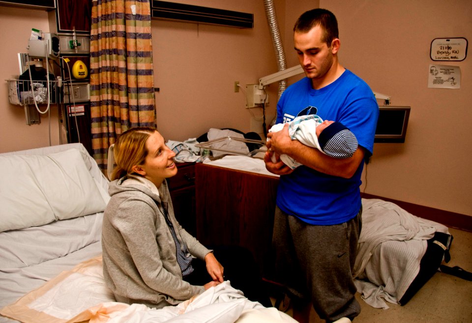 US Navy 100211-N-7498L-010 Air Force 1st Lt. Brandon Wilson and his wife greet a new addition to their family at Tripler Army Medical Center