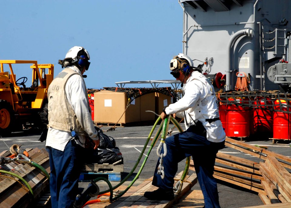 US Navy 100212-N-7638K-011 Lt. Jeffery Dolan and Boatswain's Mate 1st Class Jay Collette prepare building materials for transport to La Gonave Island, Haiti