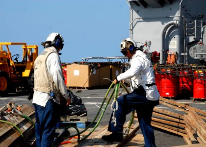 US Navy 100212-N-7638K-011 Lt. Jeffery Dolan and Boatswain's Mate 1st Class Jay Collette prepare building materials for transport to La Gonave Island, Haiti