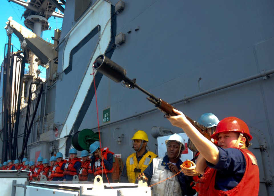 US Navy 100207-N-9950J-099 Gunner's Mate 2nd Class Andrea Davis prepares to fire the phone and distance line from the forward-deployed amphibious assault ship USS Essex (LHD 2)