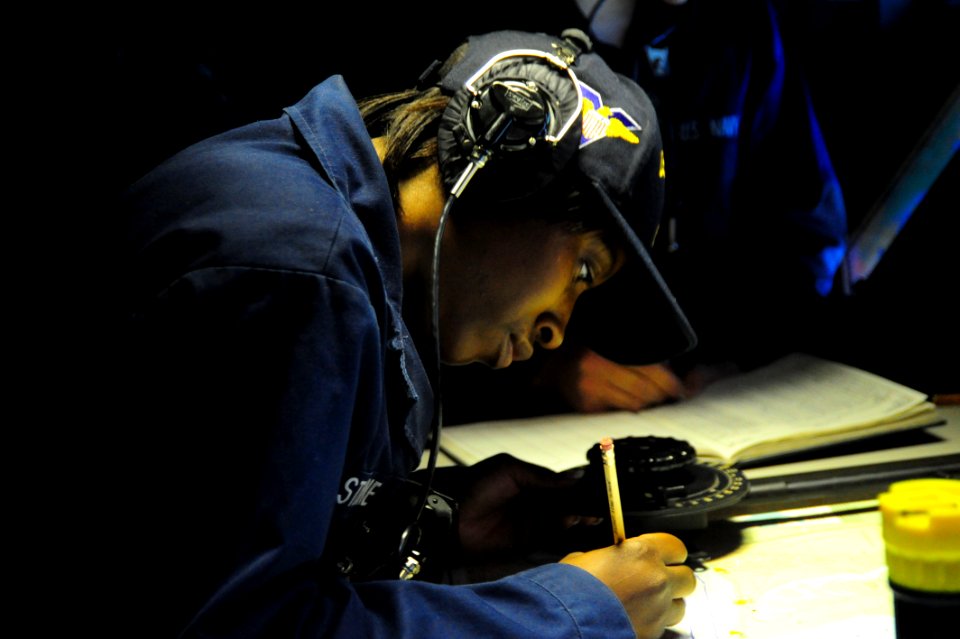 US Navy 100209-N-2953W-017 Quartermaster 2nd Class Candice Stone plots the course of the Nimitz-class aircraft carrier USS Carl Vinson (CVN 70)