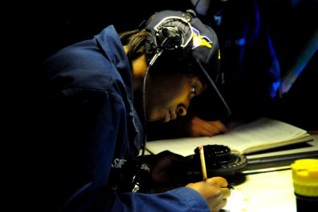 US Navy 100209-N-2953W-017 Quartermaster 2nd Class Candice Stone plots the course of the Nimitz-class aircraft carrier USS Carl Vinson (CVN 70)