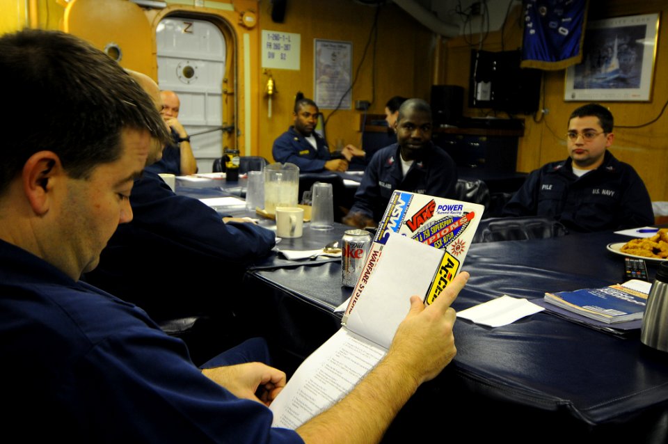US Navy 100213-N-1688B-064 Senior Chief Fire Controlman Robert Jones asks questions about combat systems during an examination board for the Enlisted Surface Warfare qualification aboard the guided-missile cruiser USS Hue City