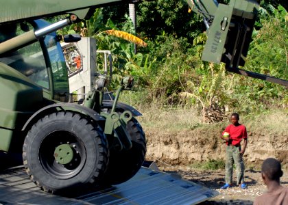US Navy 100213-N-2000D-026 Seabee unloads humanitarian supplies in Haiti