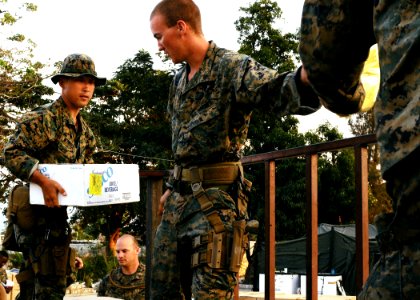 US Navy 100209-N-1092P-816 Marines assigned to the 22nd Marine Expeditionary Unit (22nd MEU), embarked aboard the amphibious assault ship USS Bataan (LHD 5), assist with the loading of humanitarian aid supplied by the Maritime