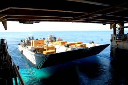 US Navy 100209-N-4971L-063 Landing craft mechanized boats from Assault Craft Unit (ACU) 2, depart the amphibious dock landing ship USS Fort McHenry (LSD 43) with relief supplies