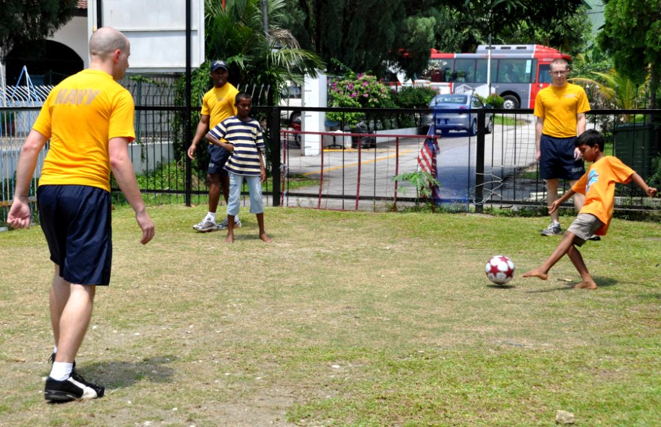US Navy 100209-N-8421M-074 Sailors assigned to the aircraft carrier USS Nimitz (CVN 68), play soccer with children at the Rumah Ozanam 1 home for boys during a community service project in Kuala Lumpur, Malaysia