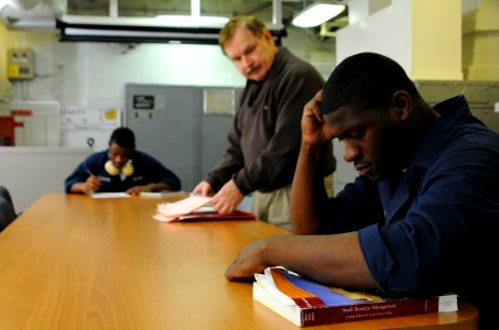 US Navy 100214-N-1688B-533 ogistics Specialist Seaman William Selmon takes his final exam for a Programs Afloat College Education (PACE) course aboard the guided-missile cruiser USS Hue City (CG 66)