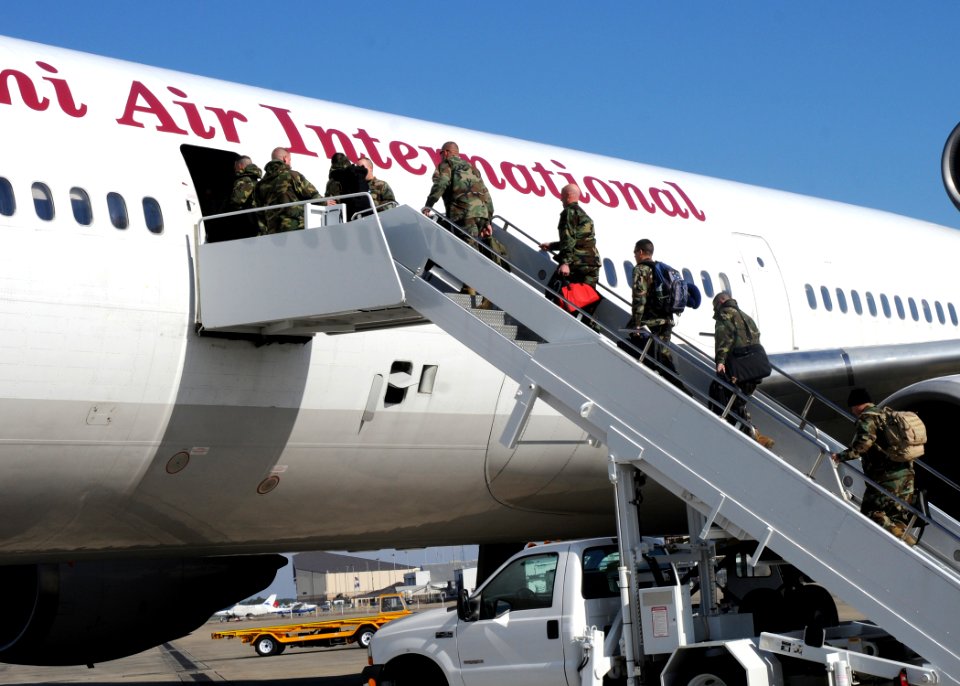 US Navy 100210-N-6357K-003 Seabees assigned to Naval Mobile Construction Battalion (NMCB) 7 board a plane at the Gulfport Air National Guard Training Center to fly to Naval Station Rota, Spain