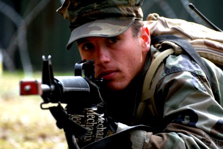 US Navy 100211-N-0475R-199 Construction Electrician 3rd Class Ronnie Snyder sights his weapon in the prone position during Operation Bearing Duel 2010