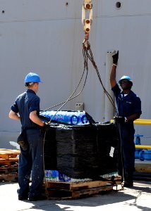 US Navy 100210-N-8241M-002 Sailors load food and humanitarian supplies aboard the amphibious dock landing ship USS Carter Hall (LSD 50) at Guantanamo Bay, Cuba