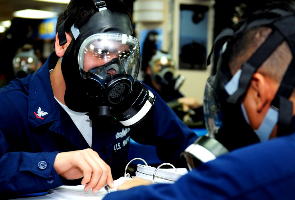 US Navy 100211-N-7280V-213 Damage Controlman 3rd Class Alfred Gonzalez trains Sailors during a chemical, biological and radiological drill aboard the U.S. 7th Fleet command ship USS Blue Ridge (LCC 19)