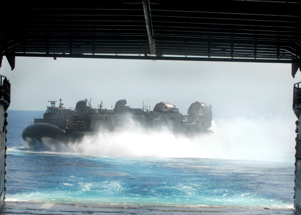 US Navy 100212-N-2000D-264 Air-Cushion Landing Craft (LCAC) 27, assigned to Assault Craft Unit (ACU) 4, departs the amphibious dock landing ship USS Carter Hall (LSD 50)