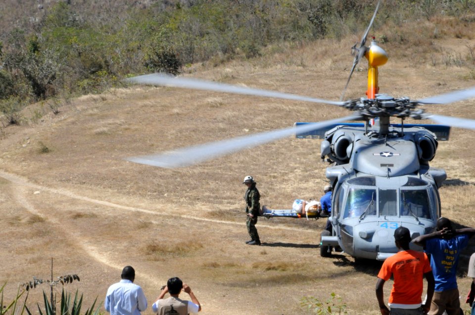 US Navy 100212-N-4995K-051 Lt. Cmdr. Matthew McLean helps carry a Haitian patient from an MH-60S Sea Hawk helicopter